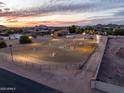 Large outdoor equestrian arena with jumps, perfect for training and riding, set against a picturesque sunset at 6861 W Calle Lejos --, Peoria, AZ 85383