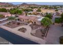 Stunning desert home with a circular driveway, lush landscaping, and mountain views at 6861 W Calle Lejos --, Peoria, AZ 85383