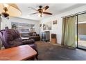 Cozy living room featuring dark brown furnishings and a large window at 7807 E Main St # E2, Mesa, AZ 85207