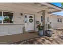 Inviting front porch with a wreath and decorative plants enhancing the entrance at 818 N Terrace St, Mesa, AZ 85203