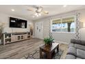 Cozy living room featuring modern decor, a large window, and hardwood floors at 818 N Terrace St, Mesa, AZ 85203