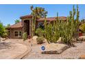 Beautiful custom home featuring desert landscaping, mature cacti, and an ADT security system sign at 8606 S Dorsey Ln, Tempe, AZ 85284