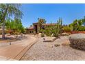 Beautiful custom home featuring desert landscaping, mature cacti, and an ADT security system sign at 8606 S Dorsey Ln, Tempe, AZ 85284