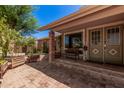 Welcoming front porch with brick accents, a cozy bench, and a charming entrance, creating a warm first impression at 8803 N 105Th Dr, Peoria, AZ 85345