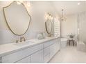Elegant bathroom featuring double sinks, a soaking tub, and modern fixtures and lighting at 9112 E Palm Tree Dr, Scottsdale, AZ 85255