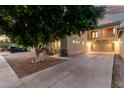 Attractive home featuring a two-car garage, a balcony, and mature landscaping at 9350 W Williams St, Tolleson, AZ 85353
