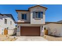 Attractive two-story home with a brown garage door and desert landscaping at 9412 E Sequence Ave, Mesa, AZ 85212
