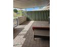 Relaxing covered patio featuring brick pavers, a grill, and a nice outdoor table at 10307 W Oakmont Dr, Sun City, AZ 85351