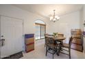 Bright dining room with tile floors, a round wood table, and a chandelier at 1350 S Greenfield Rd # 1130, Mesa, AZ 85206