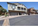 Two-story townhome featuring a stucco exterior, arched balconies, and three-car garages at 1350 S Greenfield Rd # 1130, Mesa, AZ 85206