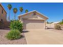 Inviting single-story home with a two-car garage and a well-manicured front yard at 15440 W Mauna Loa Ln, Surprise, AZ 85379