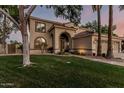 This inviting two-story home features a manicured front yard and arched entryway at 1571 E Saratoga Ct, Gilbert, AZ 85296