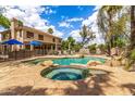 Inviting pool area features a rock-accented pool, hot tub, and ample space for relaxation at 1571 E Saratoga Ct, Gilbert, AZ 85296