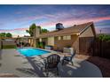 Relaxing backyard with a sparkling blue pool, covered patio, and comfortable seating, perfect for outdoor enjoyment at 1630 W Calle Del Norte --, Chandler, AZ 85224