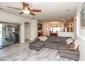 Open-concept living room with a large sectional couch, ceiling fan, and access to the patio at 18198 E El Viejo Desierto --, Gold Canyon, AZ 85118