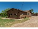 A clean single-story home with solar panels, desert landscaping and a long private driveway at 19302 W Melvin St, Buckeye, AZ 85326