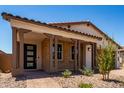 Attractive home with a brick facade, covered porch, and well-manicured desert landscaping at 19338 S 212Th Pl, Queen Creek, AZ 85142
