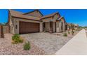 Stylish single-story home with a two-car garage and low-maintenance desert landscaping at 19354 S 212Th Pl, Queen Creek, AZ 85142