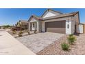 Attractive home featuring a two-car garage and low-maintenance desert landscaping at 19434 S 212Th Pl, Queen Creek, AZ 85142