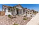 Inviting single-story home with stone accents, a two-car garage, and desert landscaping at 19434 S 212Th Pl, Queen Creek, AZ 85142