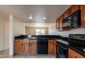 Classic kitchen featuring black appliances and tile countertops at 19601 N 7Th St # 1003, Phoenix, AZ 85024