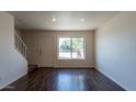 Bright living room with wood floors, large window, and staircase at 19601 N 7Th St # 1003, Phoenix, AZ 85024
