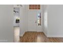 Bright foyer with tile floors, white walls, and a white front door with sidelight windows at 20352 N 109Th Dr, Peoria, AZ 85373