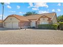 Beautiful single-story home featuring a tile roof, desert landscaping, and a spacious two-car garage at 20352 N 109Th Dr, Peoria, AZ 85373