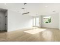 Sunlit living room features hardwood floors, white walls, recessed lighting, and modern pendant fixtures at 2130 E Turney Ave # 4, Phoenix, AZ 85016