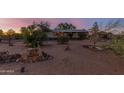 Exterior of ranch home featuring mature landscape, and address stone in a desert environment at 22216 W Bajada Dr, Wittmann, AZ 85361