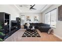 Cozy living room with a dark sofa set, elegant carpet, and a contemporary ceiling fan at 23060 E Sonoqui Blvd, Queen Creek, AZ 85142