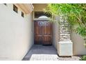 Inviting double front door with stone accents, complemented by mature landscaping at 2370 W Maplewood St, Chandler, AZ 85286