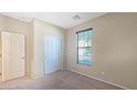Cozy bedroom featuring a window with blinds, carpeted floors, and a closet for ample storage at 23853 W Hammond Ln, Buckeye, AZ 85326