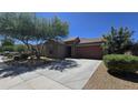 Attractive one-story home featuring well-maintained landscaping, a two-car garage, and desert landscaping at 23853 W Hammond Ln, Buckeye, AZ 85326