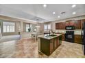 Open kitchen with granite countertops, stainless steel appliances, and ample cabinet space at 31133 N 132Nd Ln, Peoria, AZ 85383