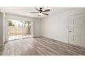 The living room features modern laminate flooring, a ceiling fan, and a sliding glass door at 3350 W Las Palmaritas Dr, Phoenix, AZ 85051