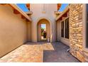 Inviting courtyard leading to the front door, featuring pavers and attractive architectural details at 4041 N Silver Ridge Cir, Mesa, AZ 85207