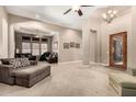 Open-concept living room with comfortable seating, neutral colors, and ample space for relaxing at 4041 N Silver Ridge Cir, Mesa, AZ 85207