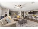 Spacious living room with an open floor plan and modern decor that flows into the dining area at 4108 N 304Th Ln, Buckeye, AZ 85396
