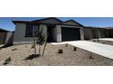 A charming home featuring low maintenance landscaping, a two car garage, and neutral tones at 4328 E Brook Lynn Pl, San Tan Valley, AZ 85143