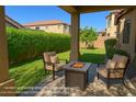 Inviting back patio with comfortable seating and a cozy fire pit, perfect for outdoor relaxation and entertaining at 7261 E Norland St, Mesa, AZ 85207
