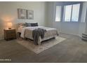 Bedroom featuring a neutral color palette, textured rug, cozy furnishings, and bright natural light at 7261 E Norland St, Mesa, AZ 85207