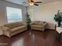 Comfortable living room with hardwood floors, neutral walls, and plenty of natural light at 7321 S 48Th Dr, Laveen, AZ 85339