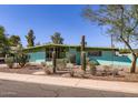 Well-maintained home with beautiful desert landscaping, including cacti and native plants at 736 E Loyola Dr, Tempe, AZ 85282