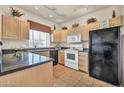 Bright kitchen featuring tiled floors, black appliances, and ample counter space at 7401 W Arrowhead Club Dr # 2067, Glendale, AZ 85308