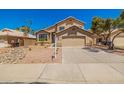 Charming two-story home with a well-maintained front yard, desert landscaping, and a two-car garage at 8478 W Grovers Ave, Peoria, AZ 85382