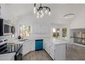 Updated kitchen showcases stainless appliances, bright lighting, and easy access to backyard through sliding glass doors at 8478 W Grovers Ave, Peoria, AZ 85382