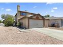 Charming two-story home with a two-car garage and desert landscaping in the front at 8876 W Bluefield Ave, Peoria, AZ 85382