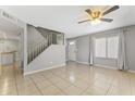Open concept living room featuring neutral paint, a ceiling fan, and tile floors at 8876 W Bluefield Ave, Peoria, AZ 85382