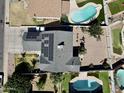 Complete aerial view of property, featuring a pool and solar panels on roof at 8908 W Sheridan St, Phoenix, AZ 85037